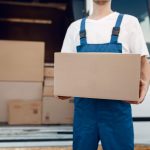 Deliveryman with carton box at the car, delivery